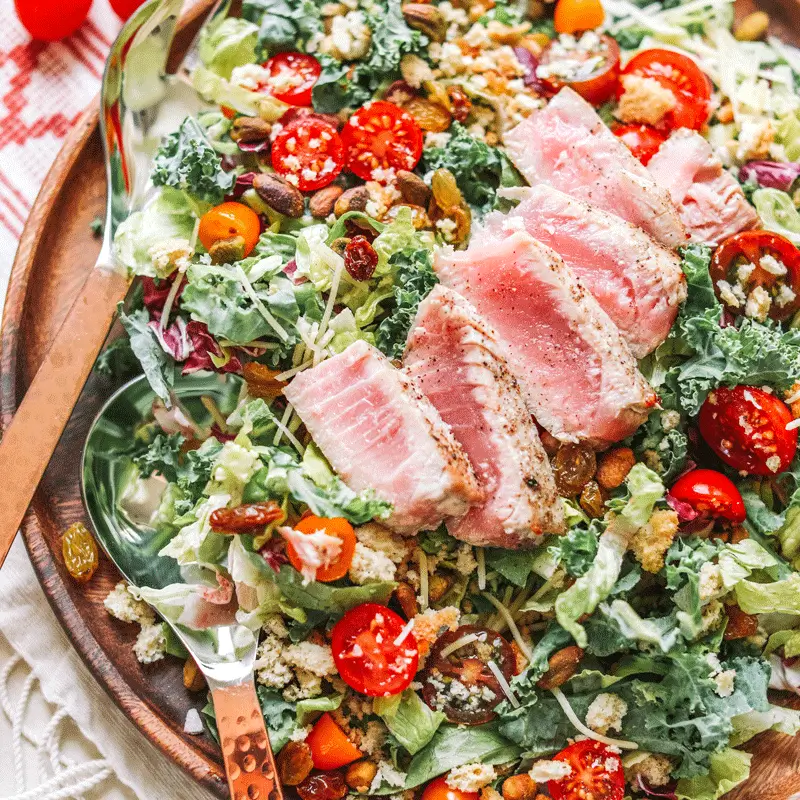 Organic Kale Caesar salad with ahi tuna, served in a fresh presentation by Taylor Farms.