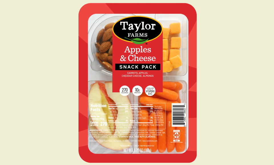 Sliced apples and cheese arranged on a wooden platter, showcasing a healthy snack option.