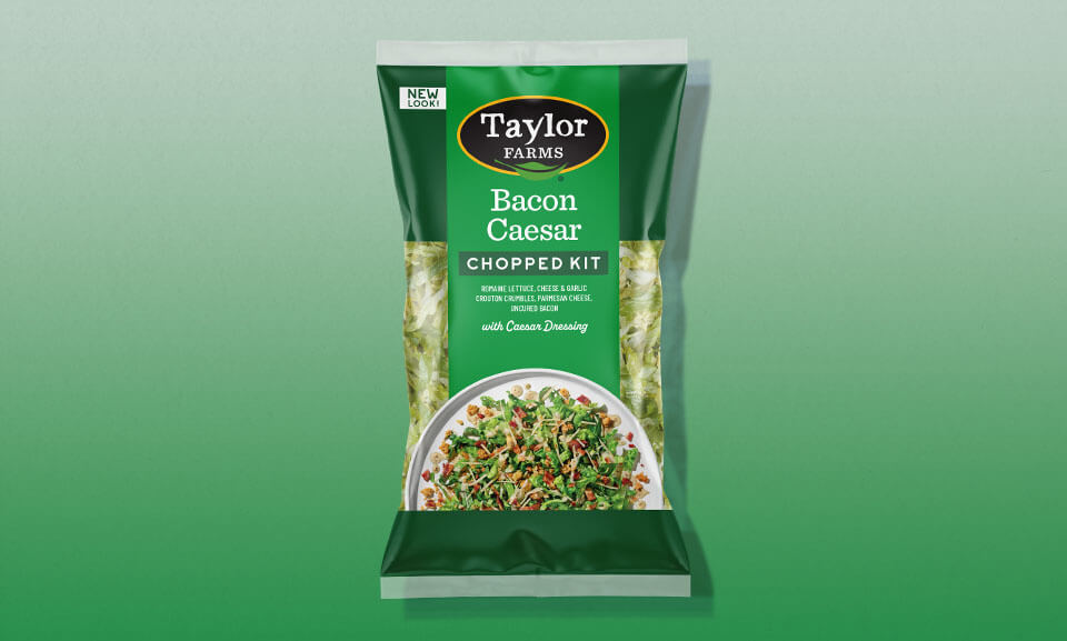 Bacon Caesar chopped salad kit featuring fresh greens, crispy bacon, and Caesar dressing.