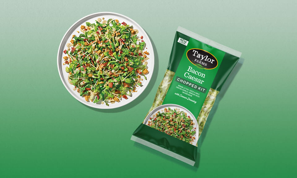 Bacon Caesar Chopped Salad Kit served on a plate with fresh greens, crispy bacon, and Caesar dressing.
