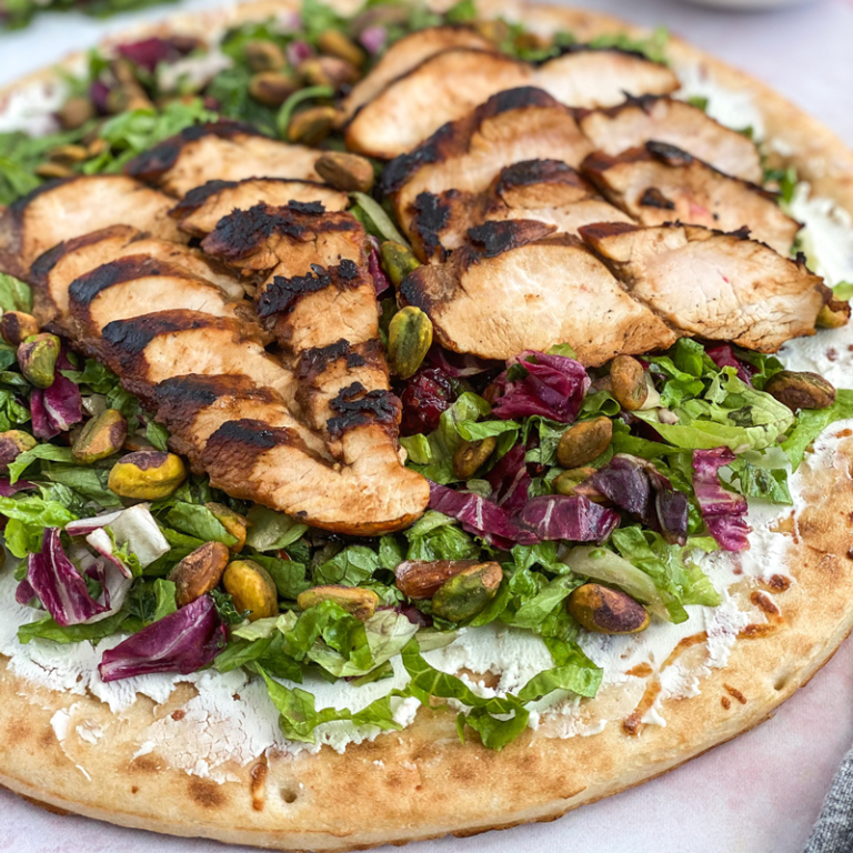 Balsamic chicken and rose flatbread topped with fresh ingredients, ideal for a delicious meal or appetizer.