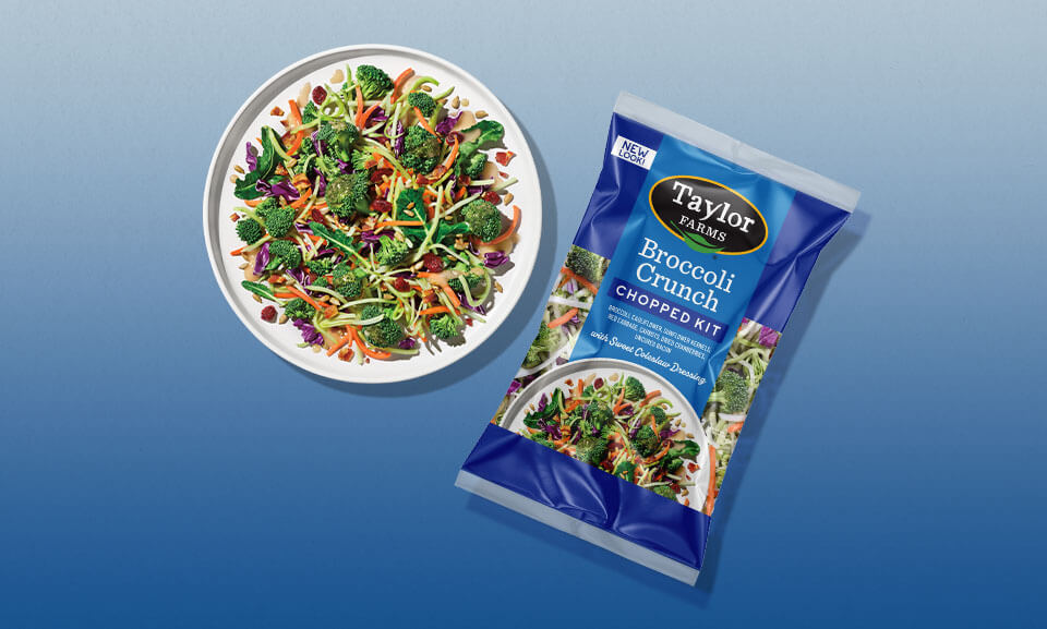 Fresh broccoli crunch chopped salad kit served in a bowl with colorful vegetables and dressing.