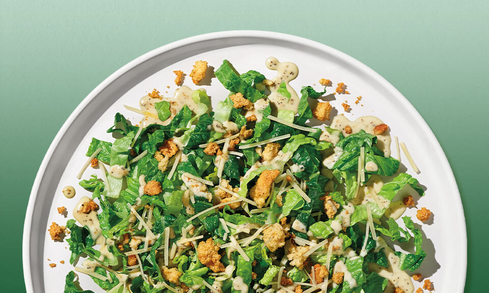 Fresh Caesar Chopped Salad Kit with romaine, parmesan cheese, croutons, and Caesar dressing in a vibrant presentation.