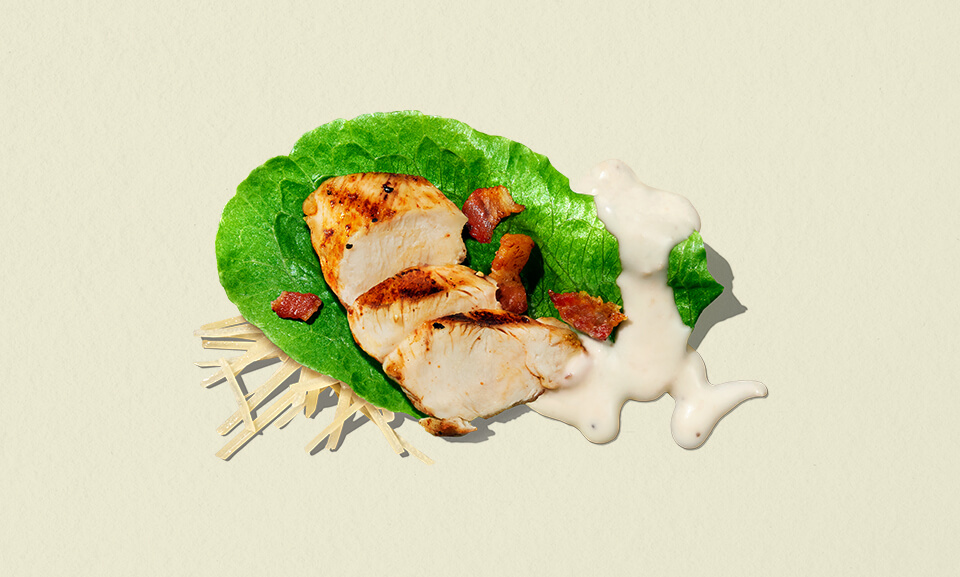 Caesar Bacon Chicken single-serve salad bowl with fresh greens, grilled chicken, bacon, and creamy dressing.