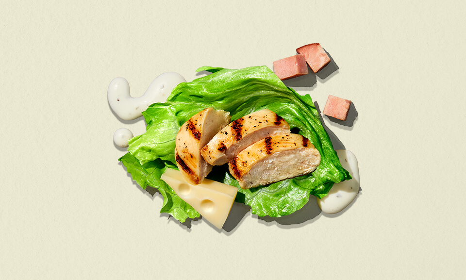 Chef-inspired chicken and ham salad in a single serve bowl by Taylor Farms, featuring fresh greens and vibrant toppings.
