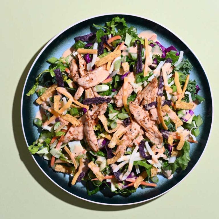 Delicious Chicken Salsa Ranch Salad with fresh greens, diced chicken, salsa, and ranch dressing.