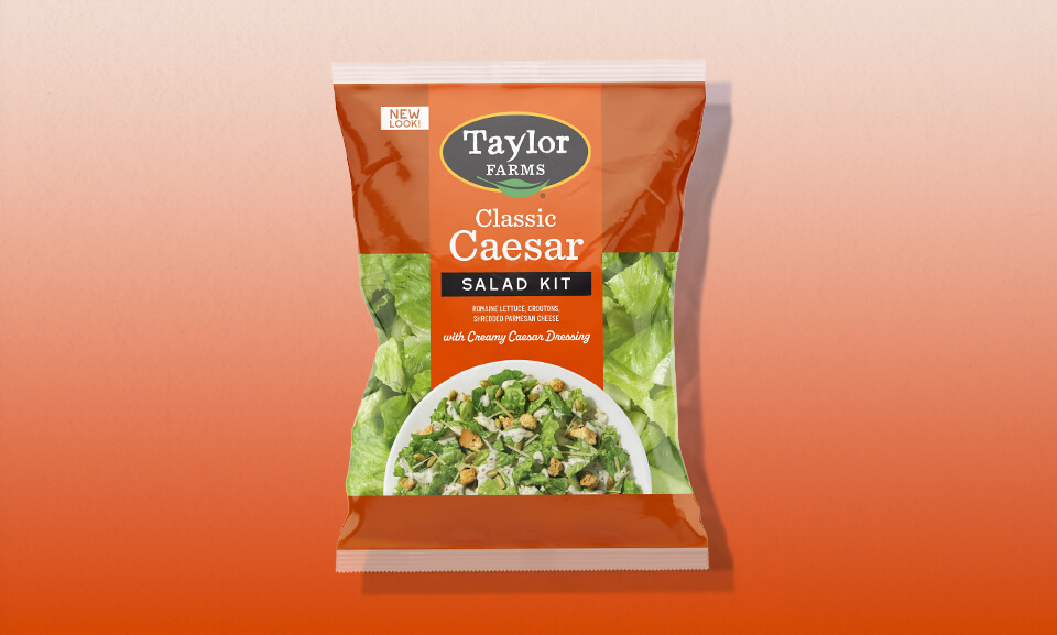 Classic Caesar salad kit featuring crisp romaine, crunchy croutons, and creamy dressing in a vibrant presentation.
