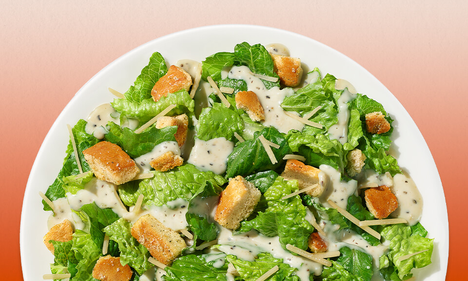 Classic Caesar salad kit featuring fresh romaine lettuce, crispy croutons, and creamy dressing, perfect for quick meals.