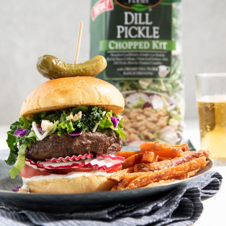 Dill pickle chopped burger featuring fresh ingredients and vibrant toppings, ideal for summer barbecues.