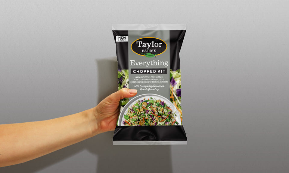 Fresh Everything Chopped Salad Kit featuring a person holding the bag, perfect for quick and healthy meals.