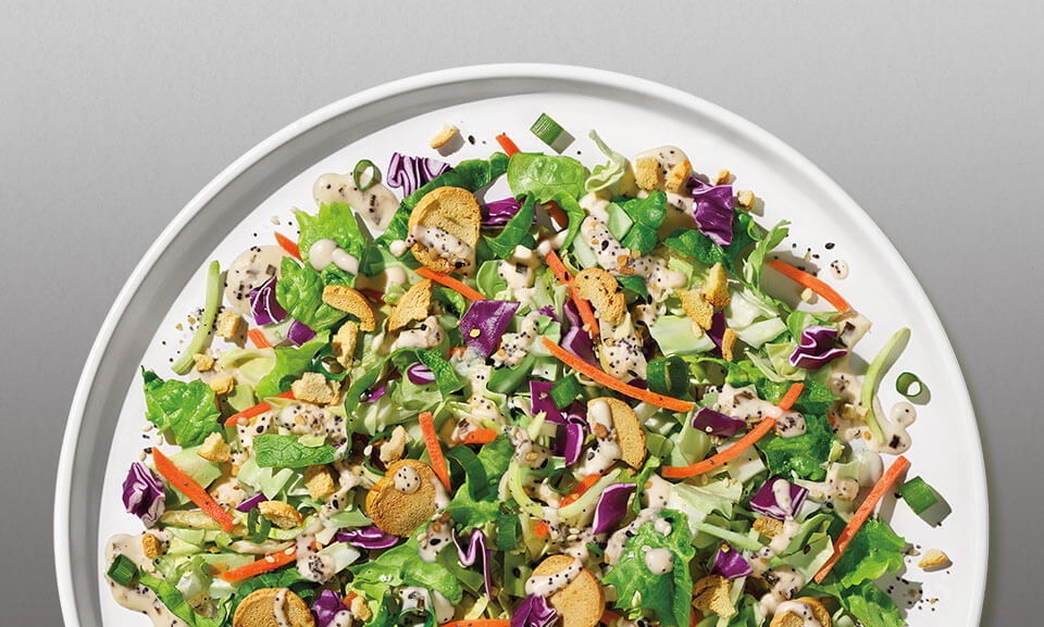 Fresh chopped salad kit featuring vibrant vegetables and toppings for a healthy meal option.