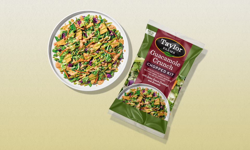 Fresh guacamole crunchy chopped salad kit served on a white plate, featuring vibrant greens and colorful toppings.