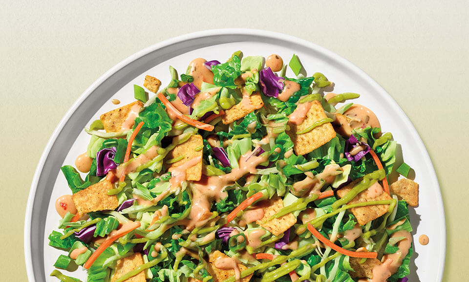Fresh Guacamole Crunch Chopped Salad Kit featuring vibrant greens, toppings, and creamy dressing in a convenient packaging.