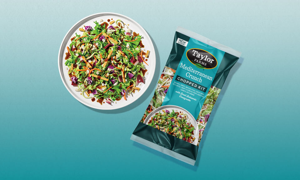 Mediterranean Crunch Chopped Salad Kit featuring fresh greens, colorful veggies, and flavorful toppings on a plate.