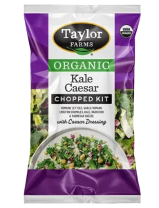 Organic kale Caesar salad with croutons and dressing in a bowl. Healthy, fresh, and nutritious meal option.