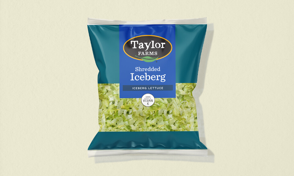Fresh shredded iceberg lettuce in an 8oz packaging for healthy salad blends.