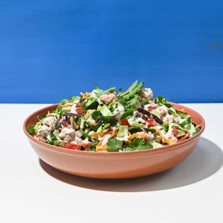 Southwest Turkey Pico Salad topped with fresh vegetables and zesty dressing, perfect for a healthy meal option.