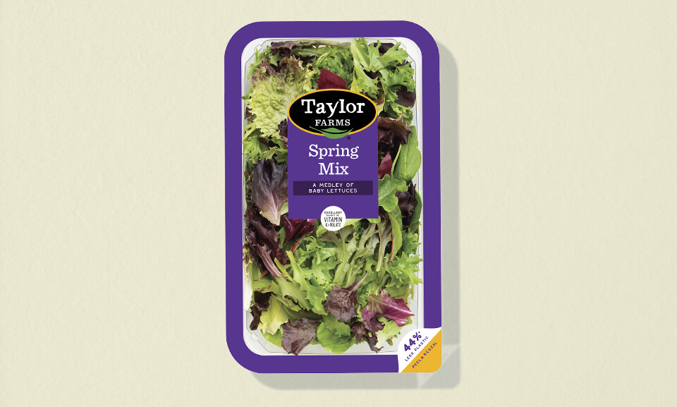 10oz package of Taylor Farms Spring Mix salad blend featuring fresh greens in resealable packaging.