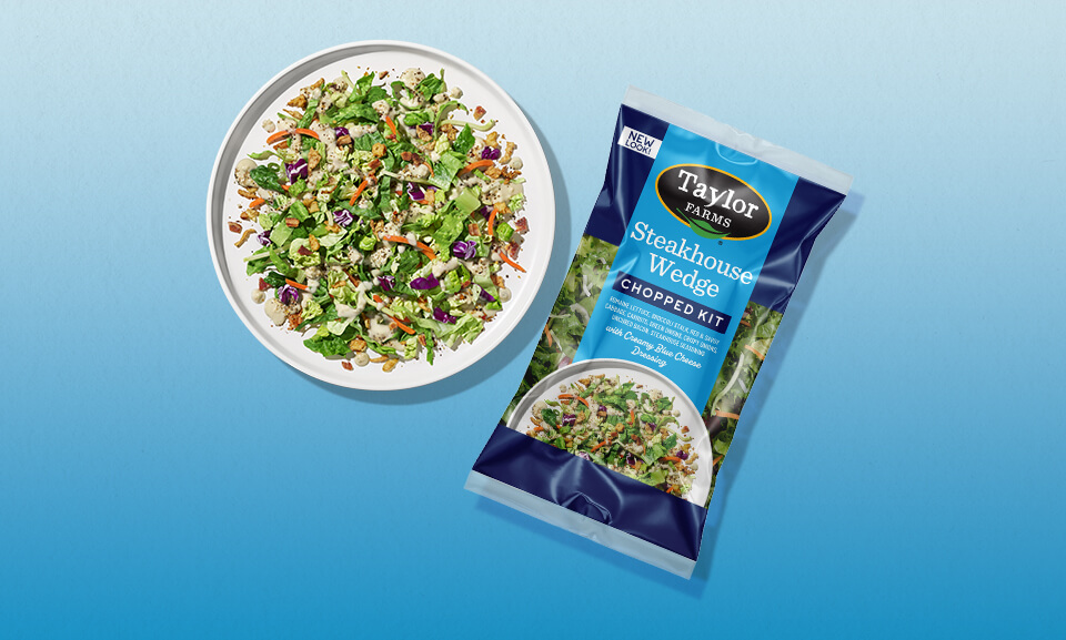Steakhouse Wedge Chopped Salad Kit with fresh vegetables and creamy dressing presented on a plate.