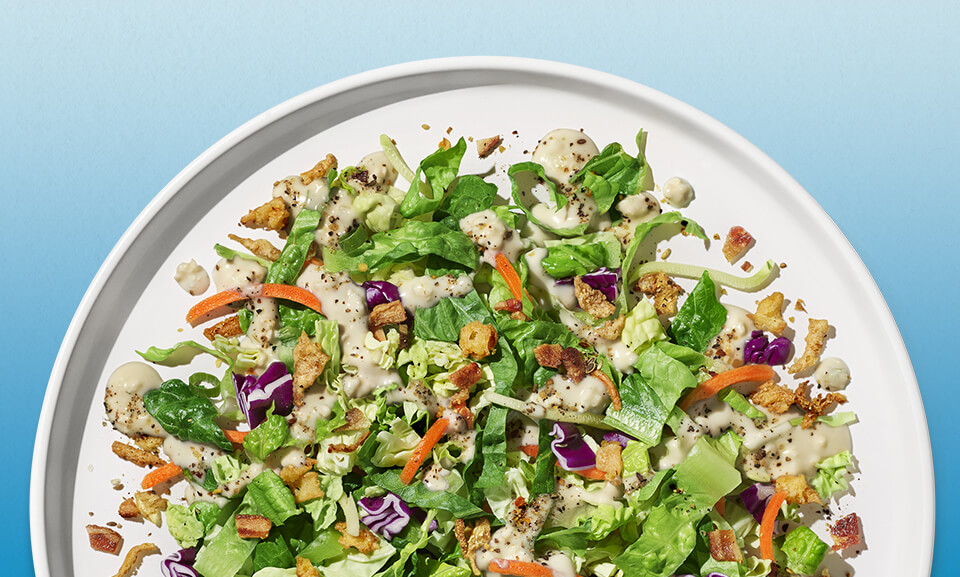 Fresh Steakhouse Wedge Chopped Salad Kit with crisp lettuce, blue cheese, and cherry tomatoes in a vibrant presentation.
