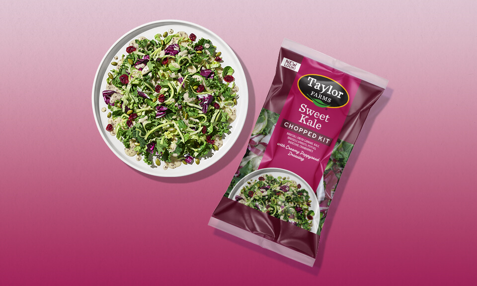 Fresh Sweet Kale Chopped Salad Kit served on a plate with colorful vegetables and dressing.