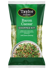 Bacon Caesar Chopped Salad Kit featuring fresh greens, crispy bacon, and Caesar dressing from Taylor Farms.