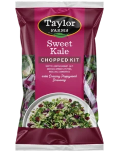Fresh sweet kale salad mix with vibrant greens, cranberries, and pumpkin seeds in a convenient packaging.