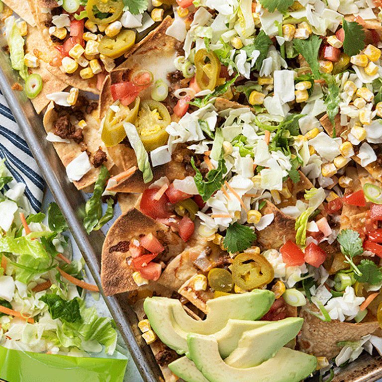 Delicious nachos topped with avocado ranch dressing from Taylor Farms.