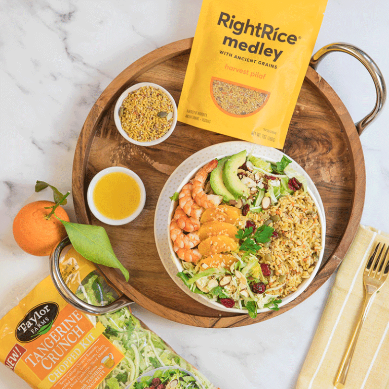 Tangerine shrimp pilaf bowl with vibrant vegetables and rice, perfect for a flavorful meal.