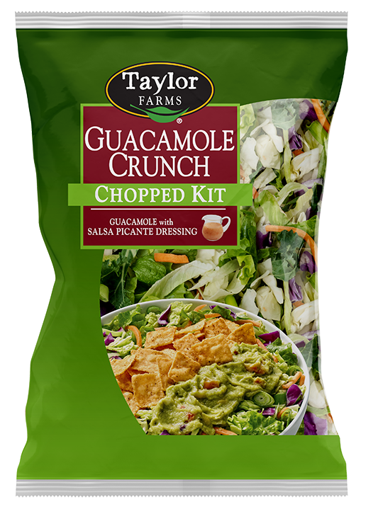 The Guacamole Crunch Chopped Salad Kit package, showing green leaf lettuce, shredded broccoli, red & savoy cabbage, carrots, and green onion, which are topped off with real guacamole, salsa picante dressing, and chili lime tortilla chips.