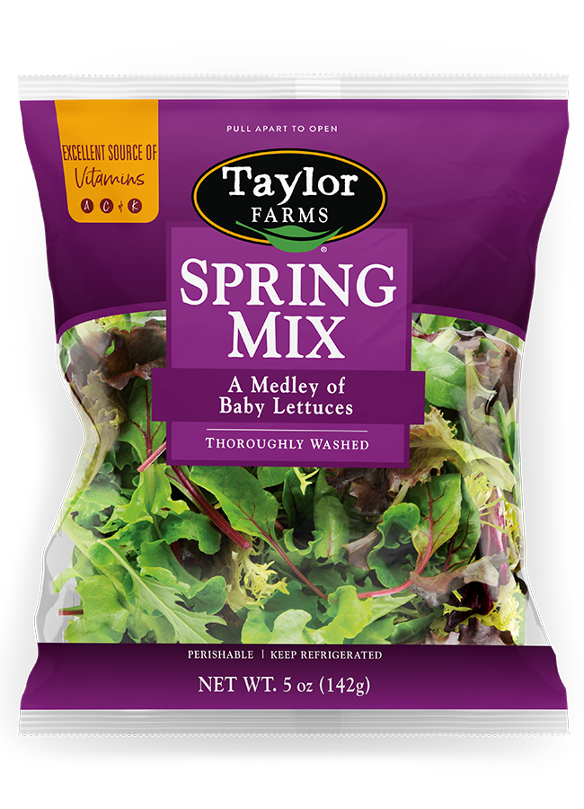 The Taylor Farms Spring Mix Salad in a purple bag, a medley of baby lettuces that is triple-washed and ready to eat.