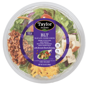 Ready-to-eat Taylor Farms BLT salad bowl featuring lettuce, tomatoes, bacon, and dressing. Perfect for a quick meal.