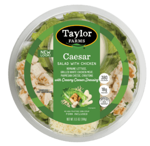 Ready-to-eat Caesar salad in a bowl featuring fresh greens, croutons, and creamy dressing.