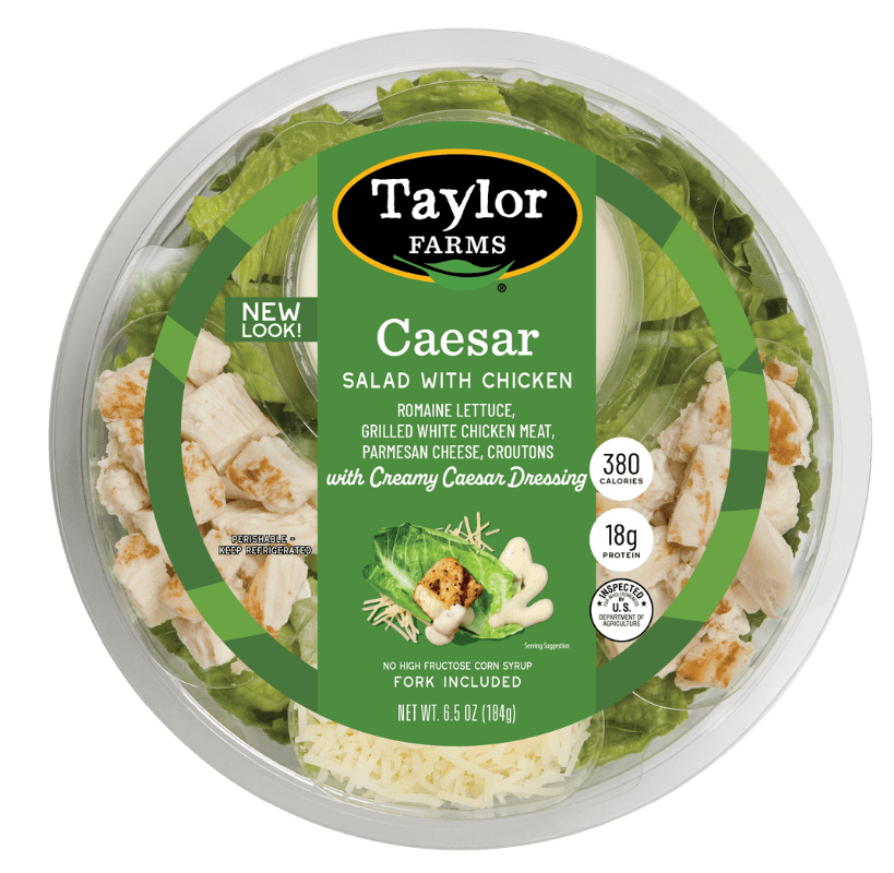 Ready-to-eat Caesar salad in a bowl featuring fresh greens, croutons, and creamy dressing.