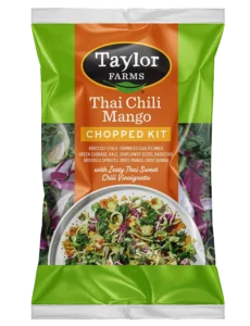 Thai chili sauce bottle with fresh chili peppers and herbs, perfect for enhancing Asian-inspired dishes.