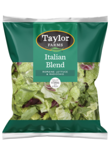Fresh leafy greens and colorful vegetables in a vibrant salad mix by Taylor Farms.
