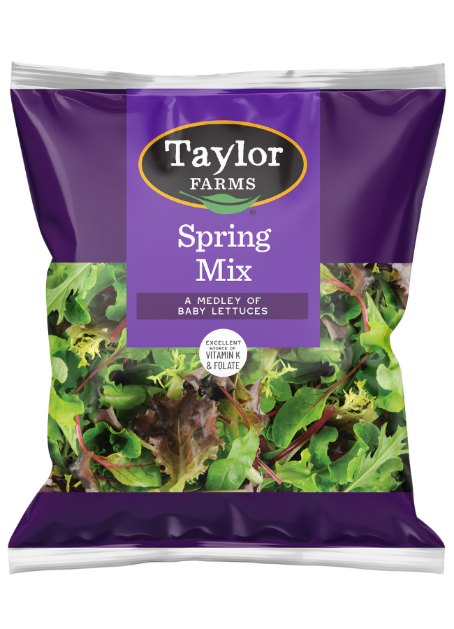 The Taylor Farms Spring Mix Salad in a purple bag, a medley of baby lettuces that is triple-washed and ready to eat.