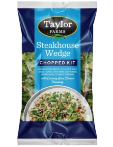 Teakhouse Wedge Salad with fresh greens, tomatoes, bacon, and blue cheese dressing.