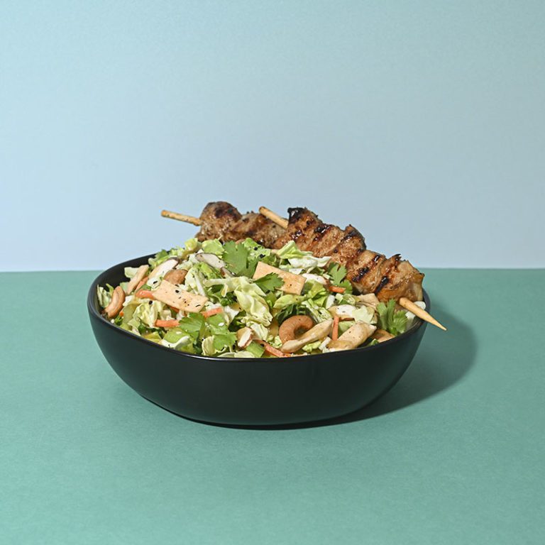Crunchy Asian cashew salad with fresh vegetables and vibrant dressing.