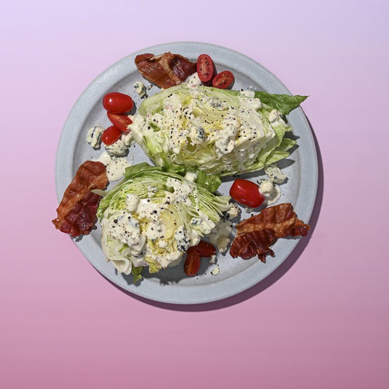 Fresh whole iceberg lettuce head from Taylor Farms with crisp green leaves, perfect for salads and dishes.