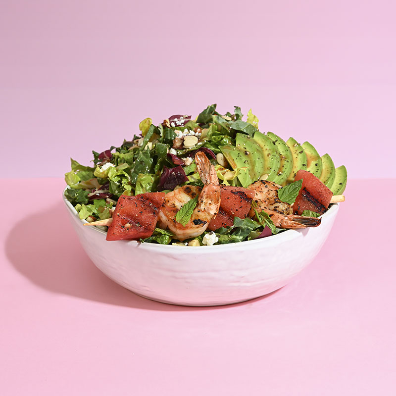 Fresh Watermelon Crunch salad with vibrant greens, juicy watermelon cubes, and crunchy toppings. Perfect summer dish.