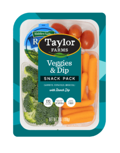 The Taylor Farms Veggies & Dip package, showing celery stalks, baby carrots, grape tomatoes, and Hidden Valley Ranch Dip.
