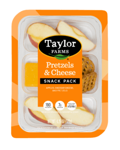 The Taylor Farms Pretzels & Cheese Snack Pack package, apple slices, cheddar cheese slices, and crispy pretzels.