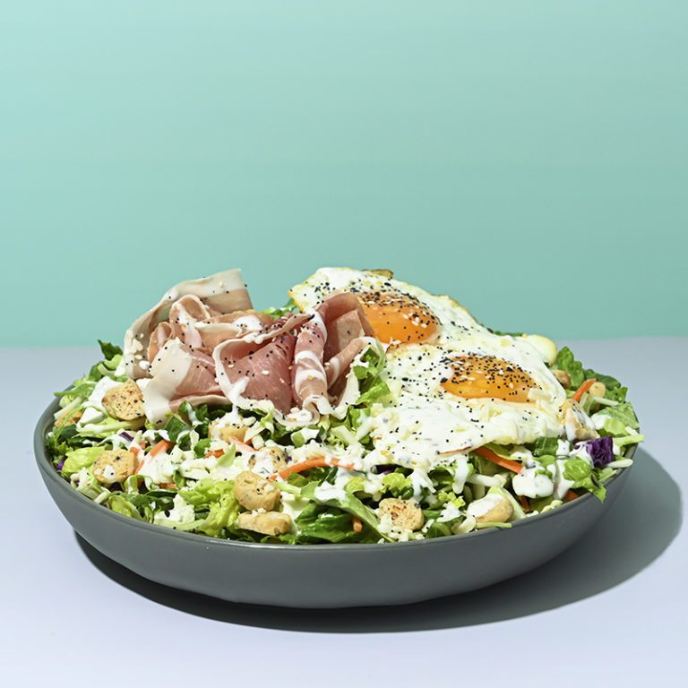 Organic Everything salad mix in a vibrant package displayed at Costco, highlighting fresh ingredients and healthy options.