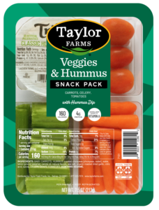Colorful platter of fresh veggies with creamy hummus dip, perfect for healthy snacking or appetizers.