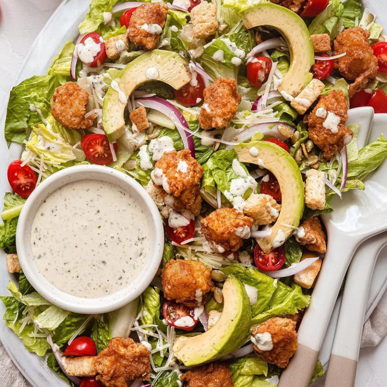 Freshly picked colorful salad mix in a bowl with vibrant greens and vegetables.