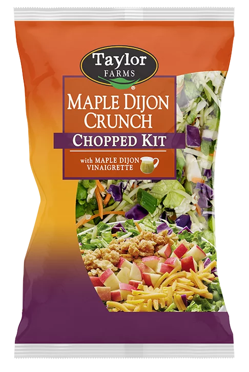 The Taylor Farms Maple Dijon Crunch Chopped Salad Kit with diced red apples, broccoli, green leaf lettuce, savoy cabbage, carrot, and red cabbage, warmly-spiced, fall-inspired crouton crumbles, sharp cheddar cheese, and a sweet & savory maple Dijon vinaigrette