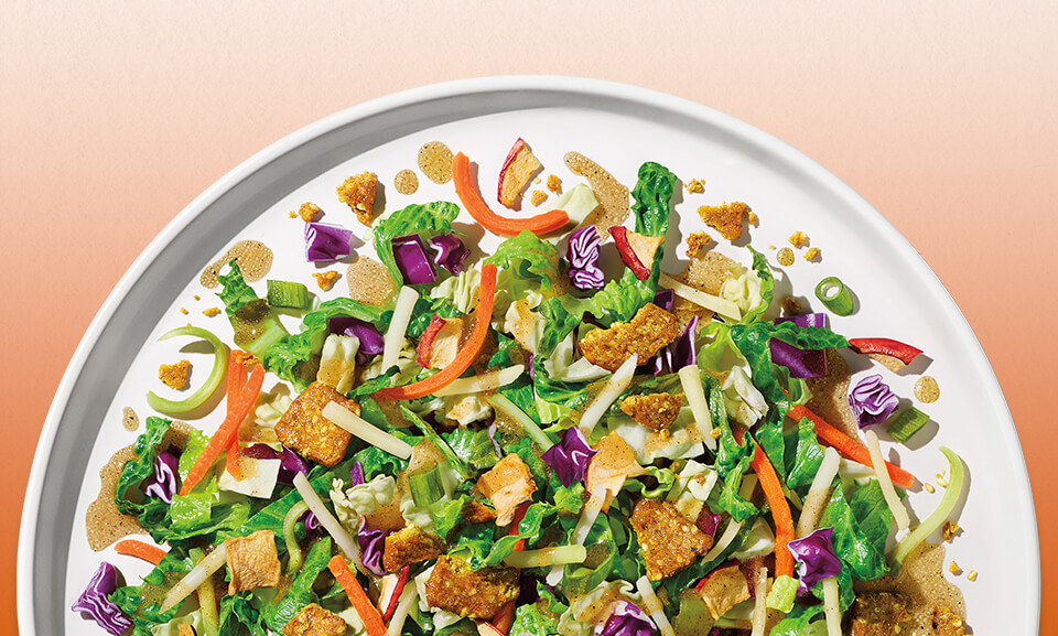 Spiced Apple Chopped Kit with fresh greens, apples, nuts, and dressing for a flavorful salad option.
