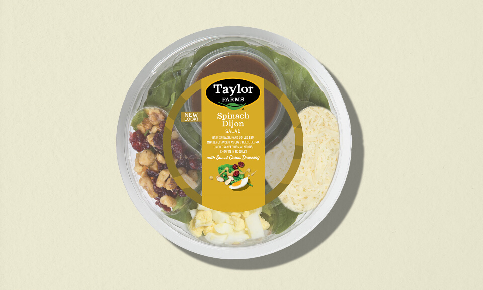 Single-serve spinach Dijon salad bowl featuring vibrant greens and a flavorful dressing, perfect for healthy meals on-the-go.