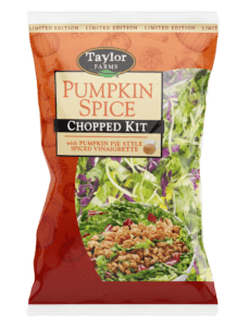 Pumpkin spice chopped salad kit with fresh greens, cranberries, and pumpkin seeds in a clear packaging.